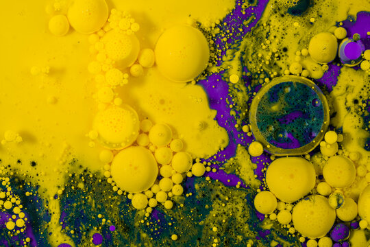 Abstract background of colorful yellow and violet drops