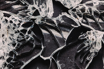 Pieces of broken glass on black table