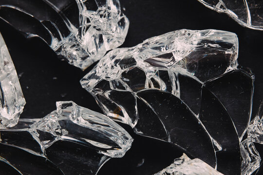 Pieces of broken glass on black table