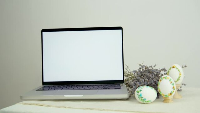 banner advertising postcard white laptop monitor screen next to lavender three embroidered painted eggs congratulations on easter place for text ad sale time with family