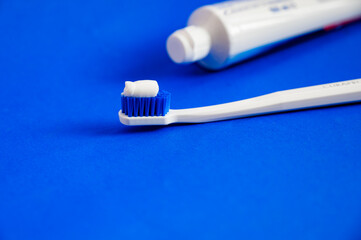 White toothbrush on a blue background. Clean your teeth text. Oral hygiene.Dental concept. health care.