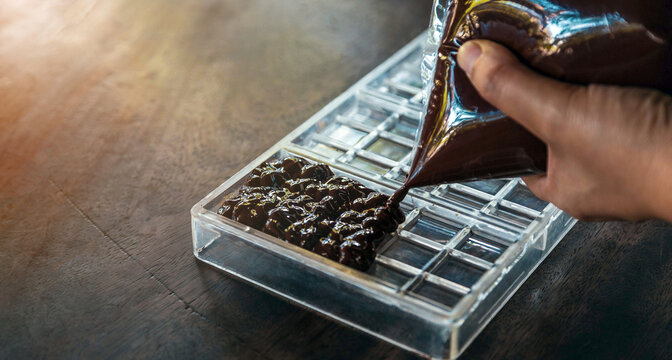 Close up of hand chef making homemade chocolate bars