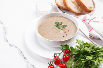 Cream soup with vegetables on cream on a white table. Soup for lunch.