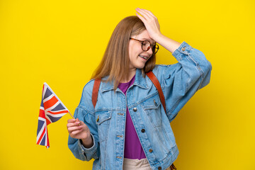 Teenager Russian girl holding an United Kingdom flag isolated on yellow background has realized something and intending the solution