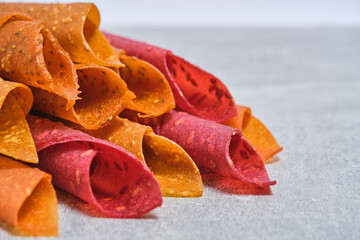 Fruit and berry pastille, dessert with nuts and seeds on a light background.