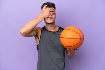 young caucasian woman  basketball player man isolated on purple background covering eyes by hands....