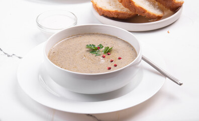 Creamy champignon soup in a white bowl.