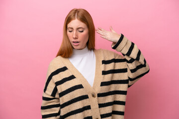 Young redhead woman isolated on pink background with tired and sick expression