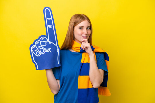 Young Redhead Sports Fan Woman Isolated On Yellow Background And Looking Up