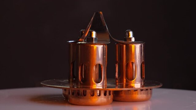 Handcrafted copper enclosure for controlling and monitoring the flow of the distilled spirits