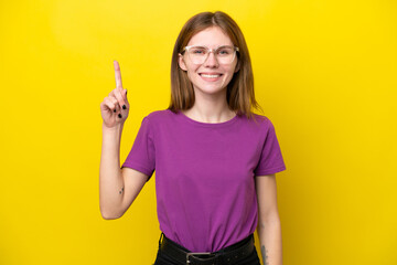 Young English woman isolated on yellow background pointing up a great idea