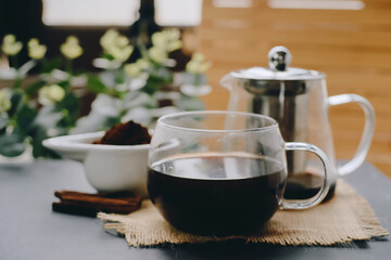 Black coffee and cinnamon sticks. Aromatic coffee from freshly ground coffee grounds.
