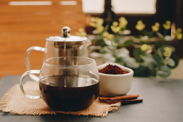 Black coffee and cinnamon sticks. Aromatic coffee from freshly ground coffee grounds.