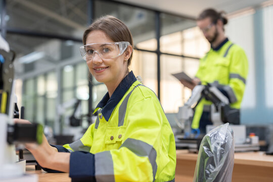 Female engineer training programable and design AI robot arm simulate in academy robotics automation laboratory room for using in manufacturing or industry