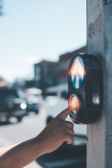 safety on the crossing street light, hand pressing pedestrian light for cross the road