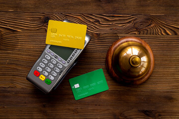 Vintage hotel service bell with payment terminal and credit cards