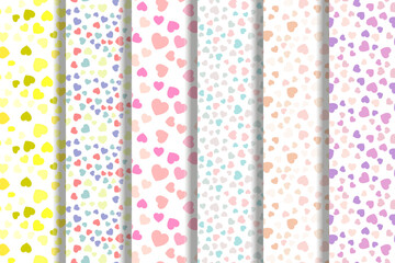 Set of vector seamless patterns of yellow, multicolored, pink, turquoise, pink hearts for fabric, textile, wallpapers, postcards, placards