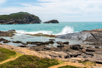 Fototapeta na wymiar Waves splashing on rock in the coast of Rio de Janeiro state in Brazil
