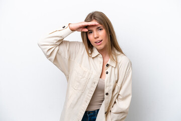 Young caucasian woman isolated on white bakcground looking far away with hand to look something