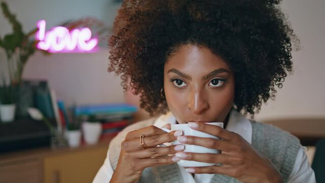 Woman tasting aromatic latte sitting restaurant closeup. Girl holding cup coffee