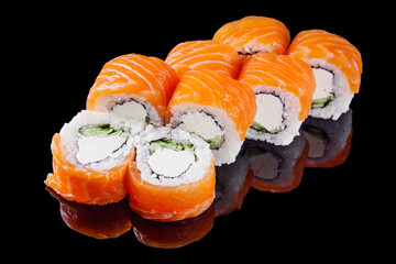 sushi roll with salmon cream cheese philadelphia cucumber on a black mirror background