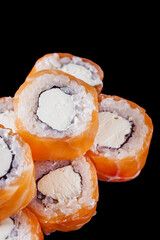 sushi roll with cream cheese philadelphia salmon on a black mirror background