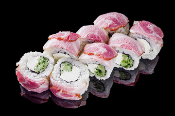 sushi roll with cream cheese cucumber bacon on a black mirror background