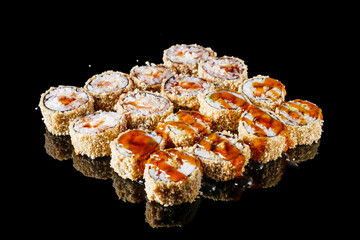 hot sushi roll tempura with eel shrimp crab salmon cream cheese cucumber avocado unagi on a black mirror background