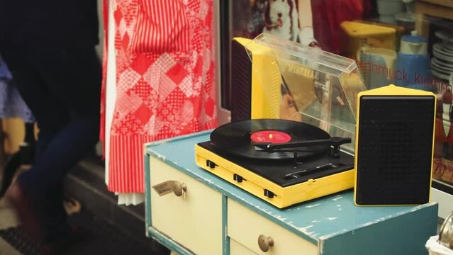 Vinyl Record On Yellow Turntable Outside Boutique