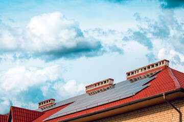 Photovoltaic or solar panels on a house with a red roof