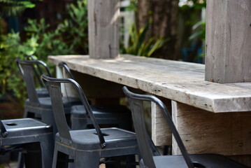 Table and chairs in outdoor cafe near  the garden.