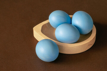Easter blue eggs on a brown background.
