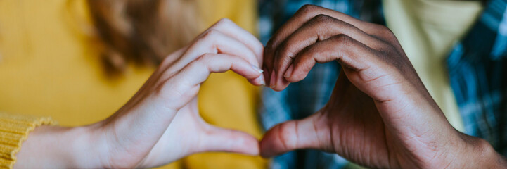couple caucasian girl and young african american man, friends support each other in difficult times, mental health and support, holding hands in shape of heart, people of different races
