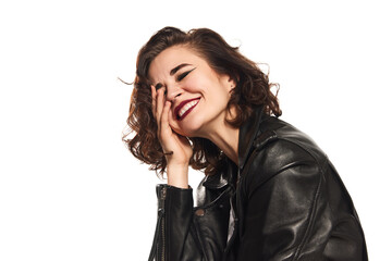 Portrait of young sexy emotional hipster woman in leather jacket laughing over white background.