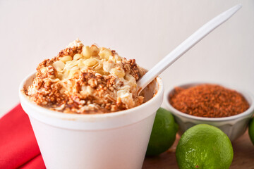 Mexican snack, prepared esquite, corn in a cup, with chili