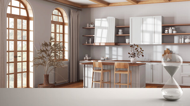 White table or shelf with crystal hourglass measuring the passing time over scandinavian kitchen, architecture interior design, copy space background