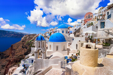 Santorini,  Oia village, Cyclades . Greece. Iconic view with blue domes and caldera of most...