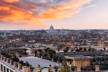 Romantic view of Rome with St Peter's Basilica (San Pietro) in Vatican City, Italy at sunset. It is...