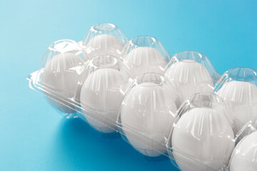 Packed egg on light blue background. Supermarket egg, grocery store egg, etc....