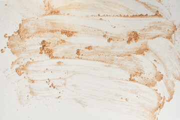 A neutral-colored face powder smeared on the surface, on a light background. Top view, flat position. Copy the location for your text. Powder texture. High quality photo