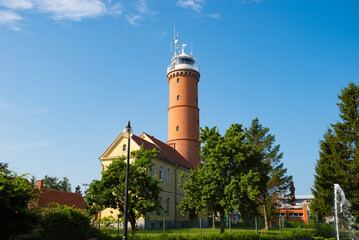 Baltic Sea lighthouse in Jaroslawiec, small coastal village in Poland - 575006065