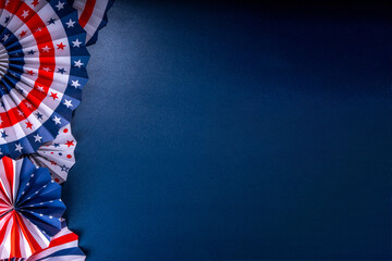 Happy Labor Day, Presidents Day, Fourth of July Independent Day, Memorial day, Columbus day background. Dark blue background with USA flag color paper fans and decorations, party accessories