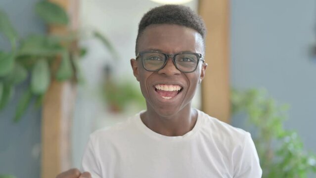 Excited Young African Man Celebrating Success, Feeling Happy