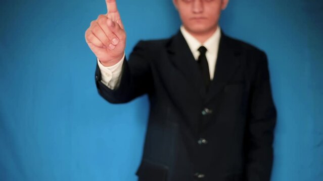 A man dressed in corporate clothes touching virtual screen gestures. blue screen footage. 24FPS HD footage.
