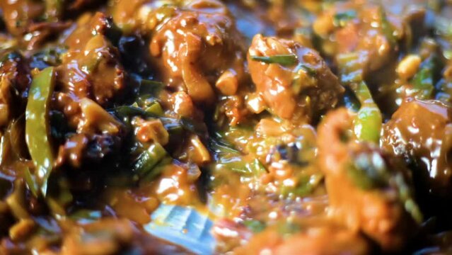 Close-up shot of chili chicken gravy on a plate. Hot spicy chili chicken.