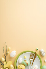 Easter decorations concept. Top view vertical photo of plates cutlery white green yellow easter eggs ceramic bunny and easter plant on isolated pastel beige background with copyspace