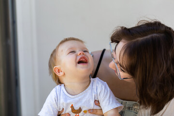 happy ten month old baby laughing with aunty outside