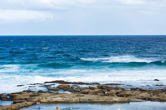 blue ocean pool rocks and sea to horizon