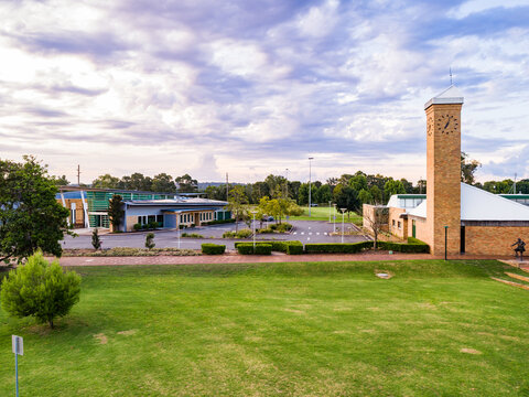 Library with empty carpark and footpath to clock tower
