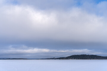 Finnish frozen lake landscape in winter with copy space.